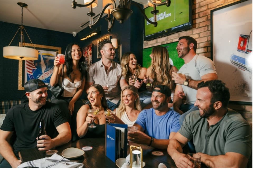 American Social people at a table having fun talking and drinking
